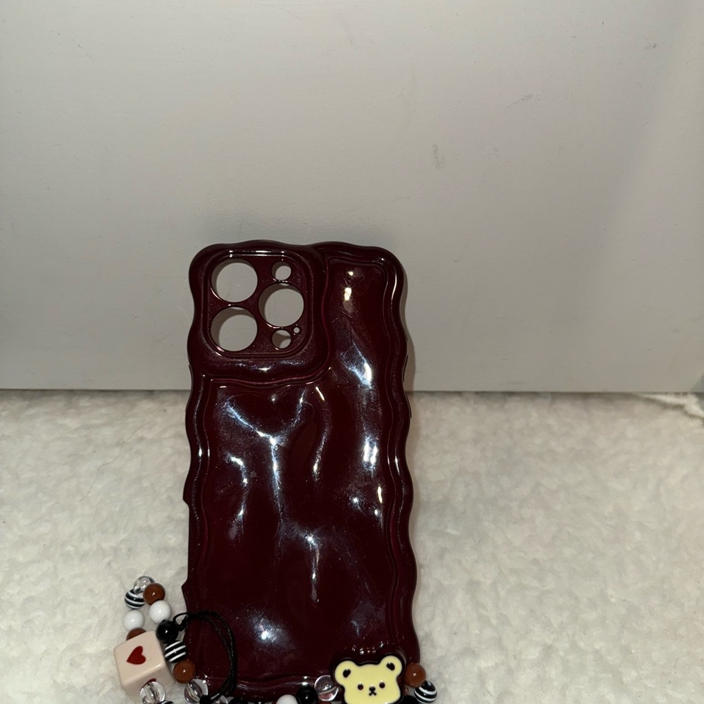 iPhone 16 Pro Max 
Stylish Burgundy Phone Case with Charm